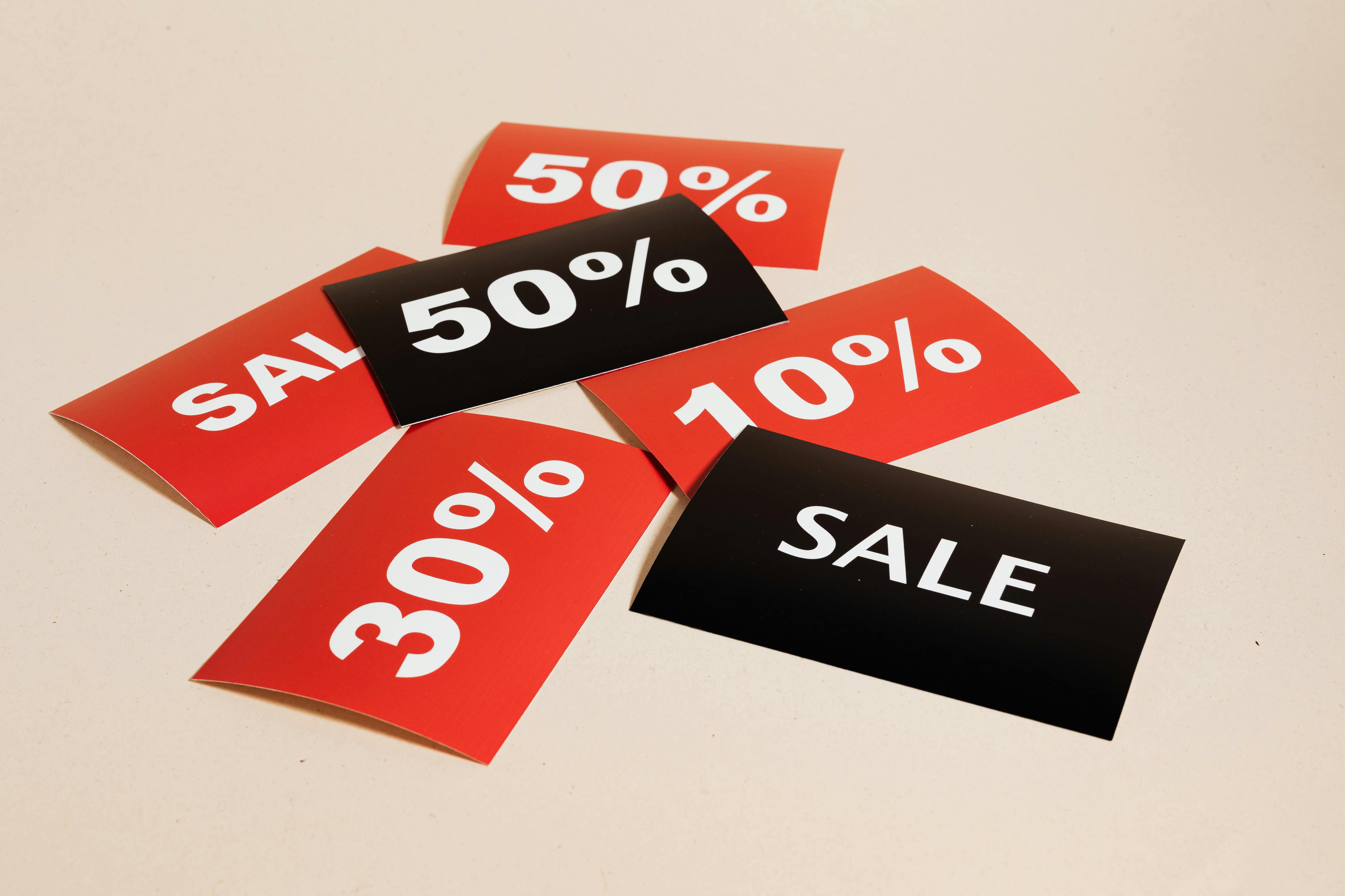 Retail environment with Foamex POS signs promoting discounts and offers near checkout counters, designed with bright colours to attract customer attention.