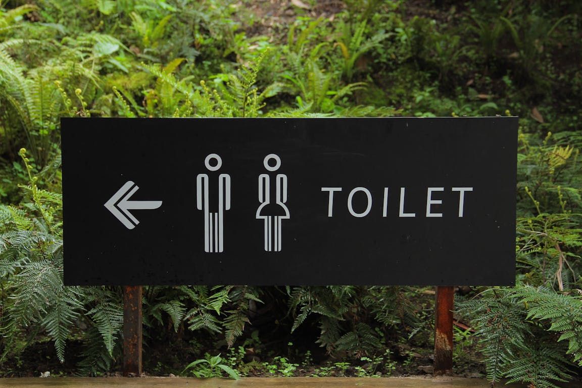 Foamex directional signage placed at an event venue, clearly guiding attendees with arrows and bold text for easy navigation.